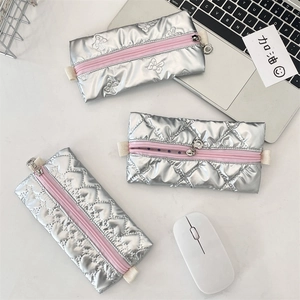 Three silver metallic PU pencil cases with bow, diamond, and heart quilting designs