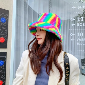 Outdoor lifestyle view of a colorful rainbow fuzzy bucket hat for women in winter