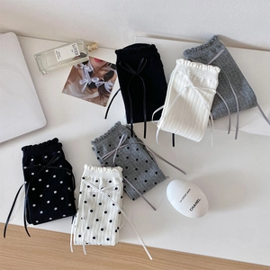 Detailed set of black, white, and grey socks with ribbon bows and polka dot patterns