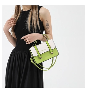 Detail of green and white PU leather messenger bag with Fashion & Bags printed text