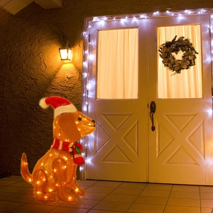 Outdoor glowing Golden Retriever Christmas dog figure with Santa hat and striped scarf