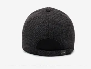 Detail view of the back of a grey tweed winter baseball cap with ribbed adjustment band