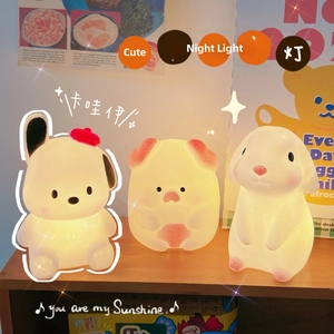 Close-up of cute cartoon puppy, pig, and rabbit silicone night lamps with warm glow