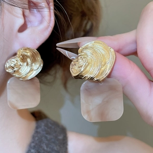 Detailed shot of vintage gold earrings with square marble acrylic pendants on model
