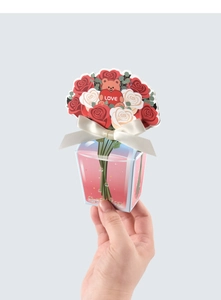 Detailed view of 3D gift card with rose bear and bow held by hand for size reference