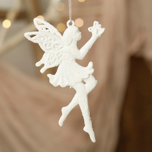 Close-up of white glittery fairy hanging ornament with wings for Christmas tree decor