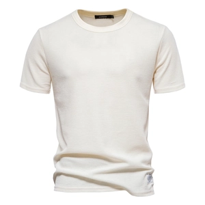 Detail of off-white waffle knit fabric texture and round neckline on men's t-shirt