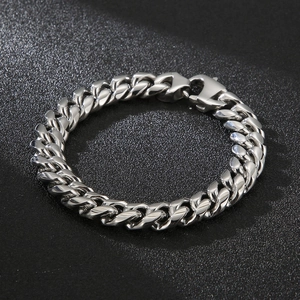 Detailed close-up of a silver stainless steel Cuban link bracelet with a lobster clasp