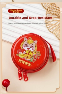 Detail of red circular tin coin purse with zodiac cartoon and double zipper closure