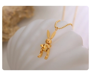 Detail of a 18K gold plated mechanical bunny pendant with Lucky engraving and ball chain