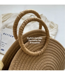 Close-up of semi-circular woven handbag showing detailed straw texture and round handles