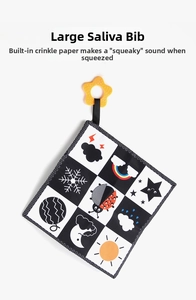 Close-up of large sensory baby bib with crinkle paper and star-shaped teether ring