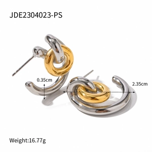Close-up of interlocking two-tone earrings with dimensions 2.35cm outer diameter