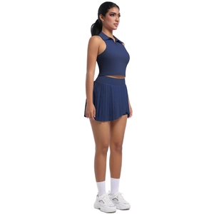 Vue détaillée de la jupe de tennis plissée bleu marine et du crop top polo sans manches