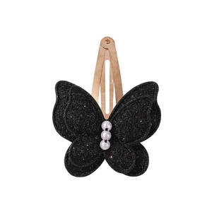 Detail of a black butterfly hair clip featuring glitter fabric and three faux pearls