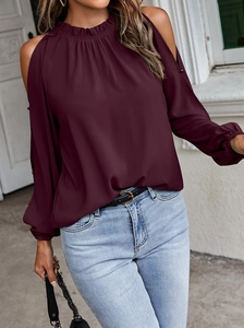 Detail of burgundy off-shoulder long sleeve top with ruffled collar and gathered cuffs