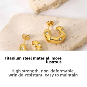 Detailed view of hammered 18K gold plated titanium steel C-hoops set with cubic zirconia