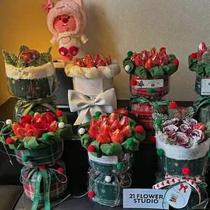 Christmas strawberry flower bouquet in red plaid wrap with festive ribbons and pine