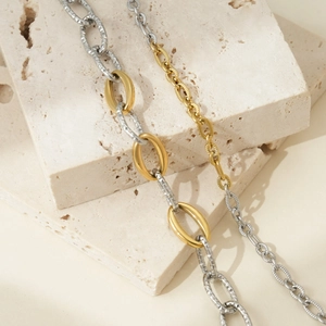 Detailed macro view of mixed gold and silver interlocking links with hammer textured finish