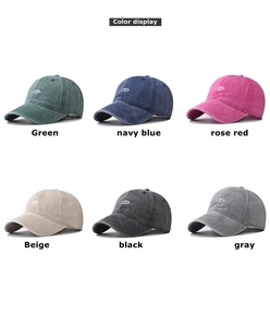 Detailed multi-color display of washed cotton baseball caps with embroidered eye logos