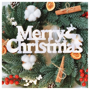 Detail of Christmas wreath featuring red berries, cotton, cinnamon, and reindeer plaque