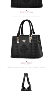 Detail of black lychee texture tote bag with symmetrical embroidery and golden logo