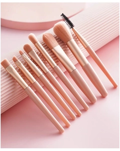 Detailed view of 8-piece pink makeup brush set with synthetic bristles on soft background