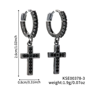 Detail of black cross earrings with zircon pavé, measuring 2.6cm by 0.8cm and 1.9g
