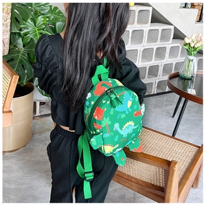 Detail view of adjustable padded green straps on kids dinosaur backpack with cartoon print