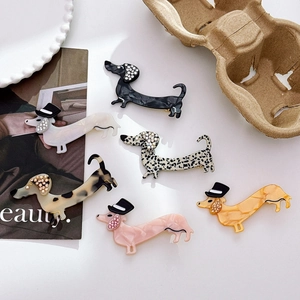 Cute dachshund acetate hair clips with rhinestones in six colors on a lifestyle background