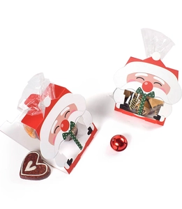 Détail de boîtes cadeaux Père Noël avec base en carton rouge et pompon blanc pour bonbons