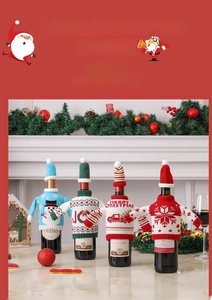Detailed view of four festive knitted Christmas wine bottle covers with holiday patterns