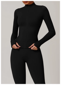 Detail of black seamless yoga jacket featuring stand collar and functional thumbholes