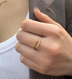 Close-up of gold-plated snake-style silver ring with marquise and pavé zircon on finger