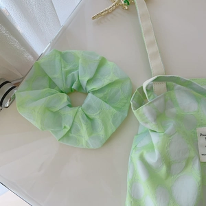 Detail of light green cotton tote bag and matching scrunchie with white ripple prints