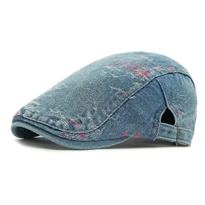 Distressed blue denim ivy cap with pink splatter print and adjustable metal buckle back