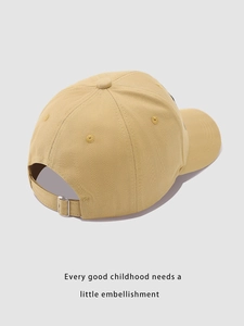 Detail view of khaki cotton baseball cap back with adjustable metal buckle and stitching