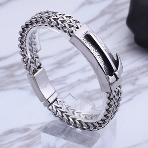 Macro detail of men's stainless steel bracelet with 316L engraved anchor clasp