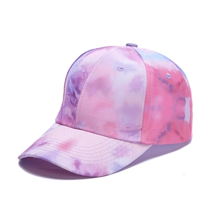 Detail of pink and blue tie-dye baseball cap with visible fabric texture and stitching