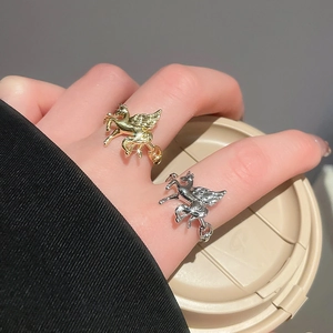 Detail view of gold and silver Pegasus rings with 3D wings and polished mirror surface