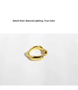 Detail shot of golden irregular wave ring featuring a polished organic texture