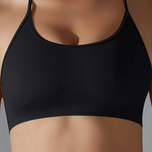 Close-up of seamless black sports bra showing ribbed support band and elastic fabric texture