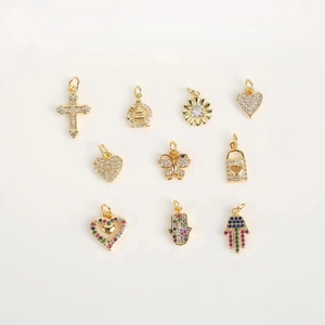 Golden mini charms with cubic zirconia in cross, sun, heart, and butterfly shapes