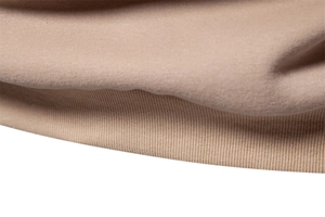 Detailed macro view of khaki cotton knit fabric with textured ribbed cuff and soft texture