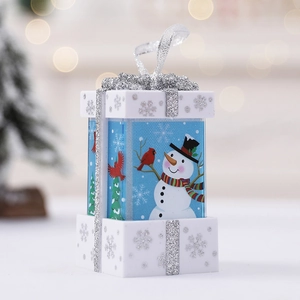 Blue and white Christmas gift box ornament with snowman illustration and silver ribbon