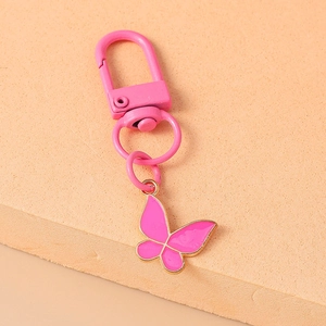 Detailed view of pink butterfly keychain with golden trim and swivel lobster clasp hook