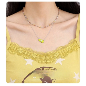 Japanese style layered silver necklace with lime green pendant and colorful beads