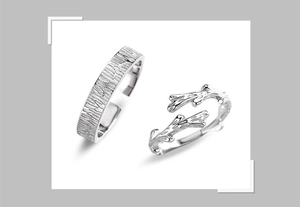 Detailed macro view of silver tree bark texture and branch design couple rings