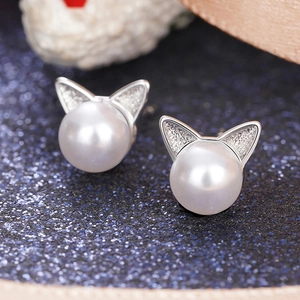 Close-up of cat ear pearl earrings with silver finish and sparkling crystal details