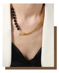 Detail of a vintage 18k gold plated titanium necklace with black onyx beads and AB chain
